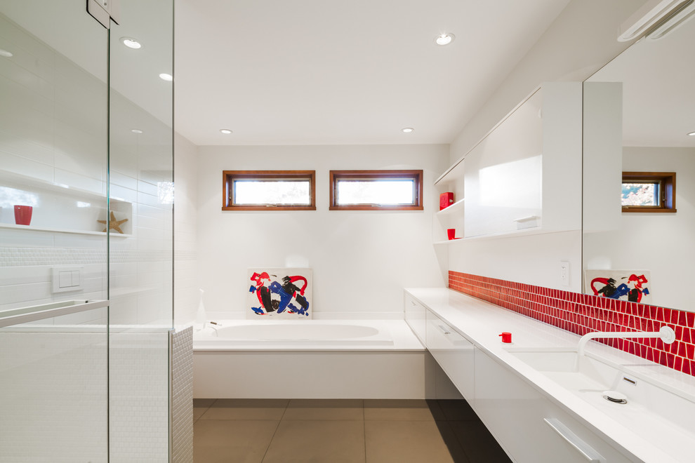 Photo of a large contemporary kids bathroom in Montreal with flat-panel cabinets, yellow cabinets, a drop-in tub, an alcove shower, a wall-mount toilet, red tile, mosaic tile, white walls, ceramic floors, an undermount sink and quartzite benchtops.