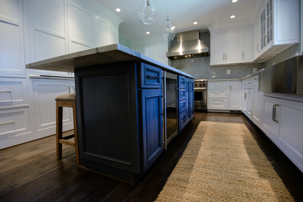 Inspiration for a large transitional u-shaped medium tone wood floor and brown floor eat-in kitchen remodel in DC Metro with a farmhouse sink, recessed-panel cabinets, white cabinets, marble countertops, stainless steel appliances and an island