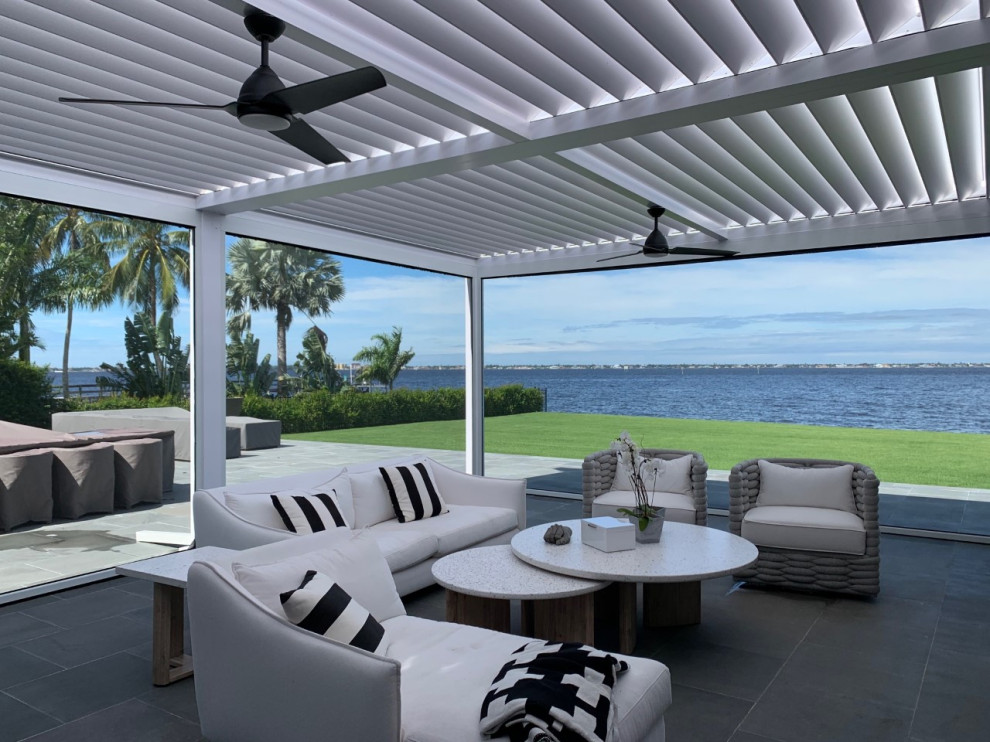 Design ideas for a medium sized nautical back private metal railing terrace in Tampa with a pergola.