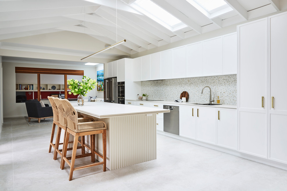 Inspiration for a large modern galley open plan kitchen in Sydney with a double-bowl sink, recessed-panel cabinets, white cabinets, engineered stone countertops, multi-coloured splashback, marble splashback, stainless steel appliances, porcelain flooring, an island, beige floors, beige worktops and exposed beams.