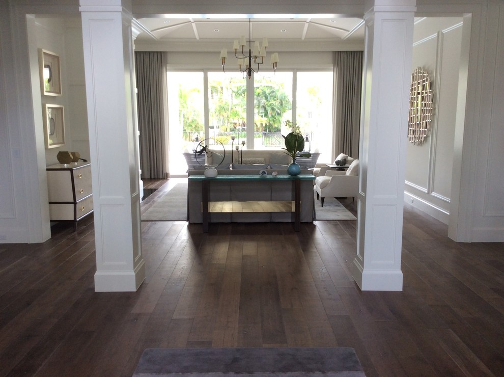 This is an example of a mid-sized transitional formal open concept living room in Miami with white walls, dark hardwood floors, no fireplace, no tv and brown floor.