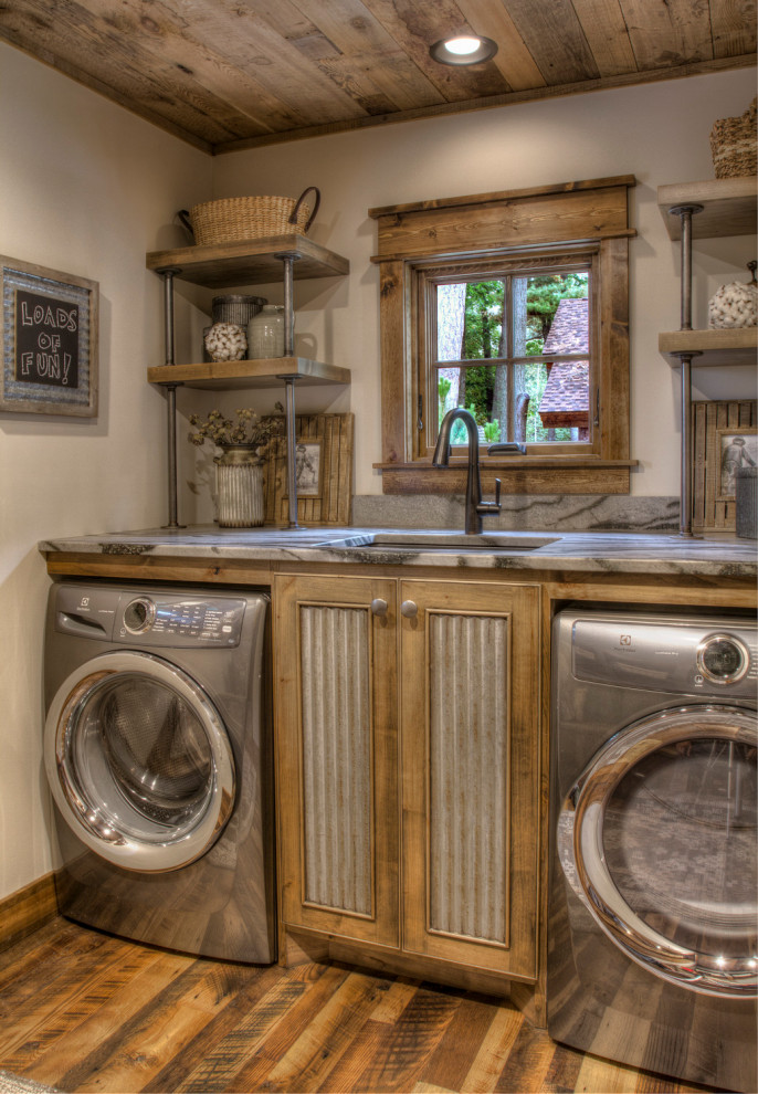 Mid-sized country single-wall dedicated laundry room in Minneapolis with an undermount sink, granite benchtops, white walls, medium hardwood floors, a side-by-side washer and dryer, multi-coloured floor and multi-coloured benchtop.