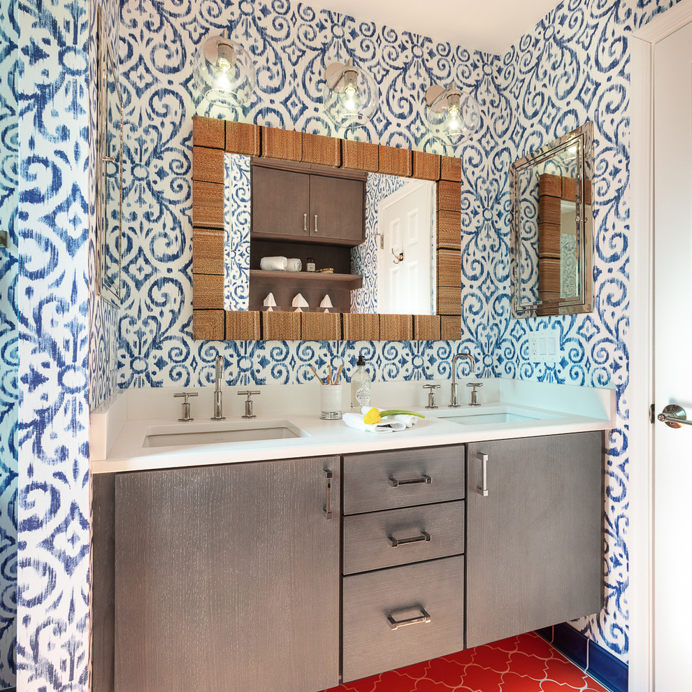 Mid-sized eclectic kids bathroom in DC Metro with grey cabinets, multi-coloured walls, ceramic floors, white benchtops, flat-panel cabinets, an undermount sink and red floor.