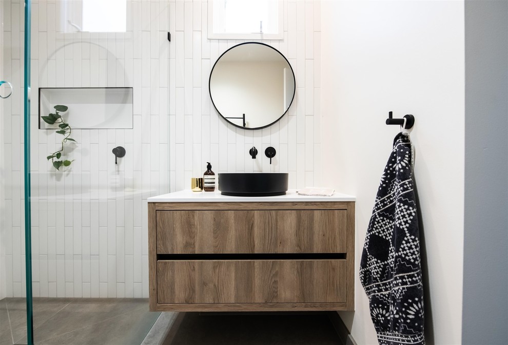 Design ideas for a mid-sized contemporary master bathroom in Melbourne with white tile, ceramic tile, white walls, porcelain floors, engineered quartz benchtops, white benchtops, flat-panel cabinets, medium wood cabinets and a wall-mount sink.