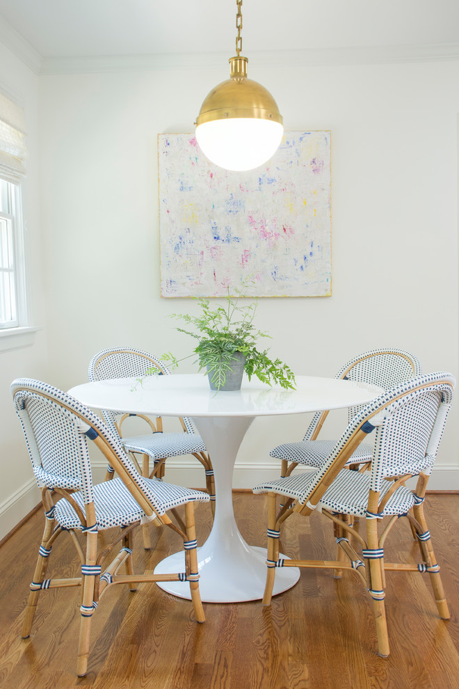 Example of a transitional l-shaped medium tone wood floor and brown floor great room design with a farmhouse sink, shaker cabinets, white cabinets, marble countertops, white backsplash, ceramic backsplash, stainless steel appliances and a peninsula