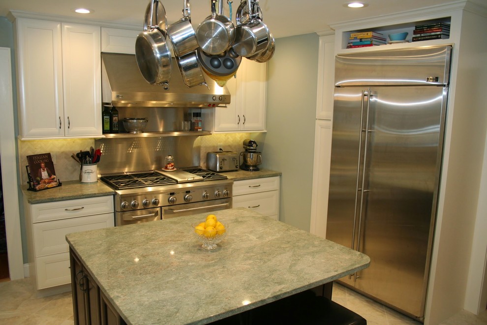 Enclosed kitchen - mid-sized transitional u-shaped ceramic tile enclosed kitchen idea in Boston with a single-bowl sink, recessed-panel cabinets, white cabinets, granite countertops, green backsplash, stone tile backsplash, stainless steel appliances and an island