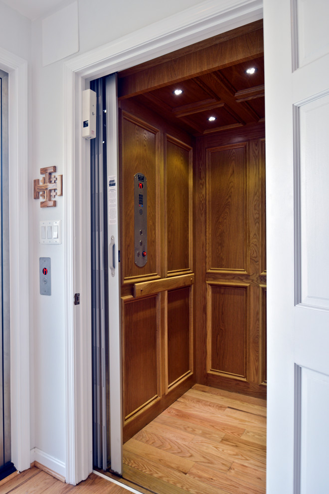 Inspiration for a huge modern light wood floor and brown floor hallway remodel in DC Metro with white walls