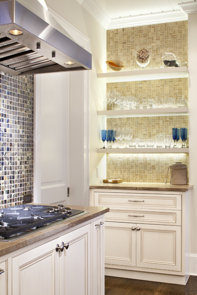 Example of a classic medium tone wood floor enclosed kitchen design in Jacksonville with beaded inset cabinets, white cabinets, limestone countertops, mosaic tile backsplash and an island