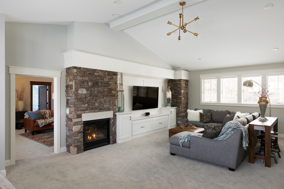 Large transitional enclosed family room in Minneapolis with grey walls, carpet, a two-sided fireplace, a stone fireplace surround, a wall-mounted tv and grey floor.