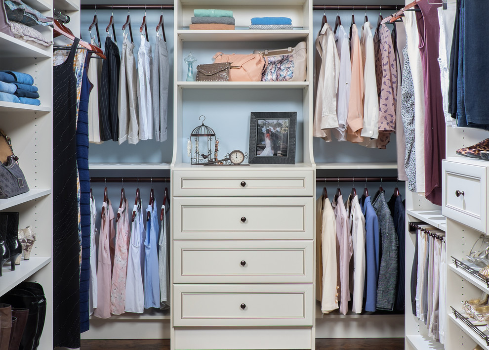 Inspiration for a mid-sized transitional gender-neutral walk-in wardrobe in Boston with recessed-panel cabinets, white cabinets and dark hardwood floors.