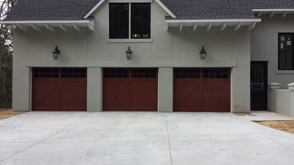 Design ideas for a large beach style attached three-car garage in Charleston.