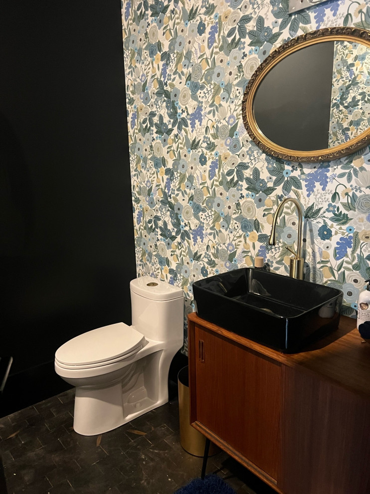 Design ideas for an urban cloakroom in Other with medium wood cabinets, wood-effect flooring, a vessel sink, a freestanding vanity unit and wallpapered walls.