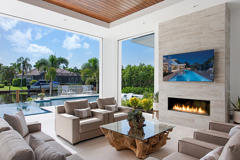 Inspiration for a contemporary patio in Miami with a roof extension.