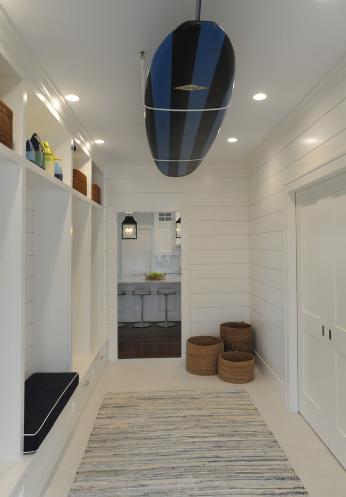 This is an example of a beach style mudroom in Boston with white walls, a double front door and a white front door.