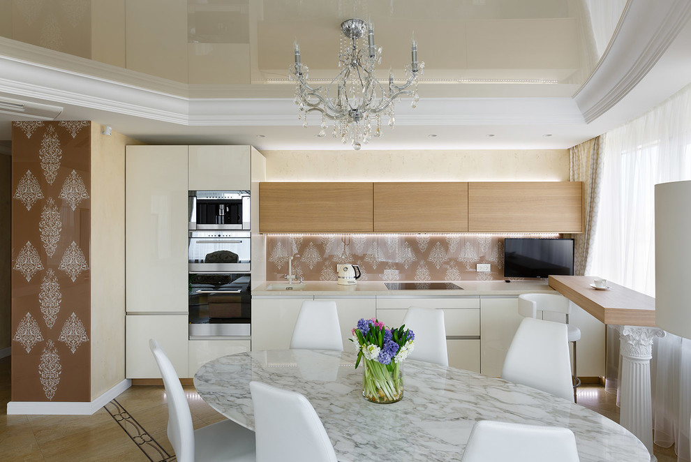 This is an example of a mid-sized eclectic single-wall open plan kitchen in Saint Petersburg with an undermount sink, medium wood cabinets, solid surface benchtops, multi-coloured splashback, glass sheet splashback, stainless steel appliances, ceramic floors, multi-coloured floor and beige benchtop.