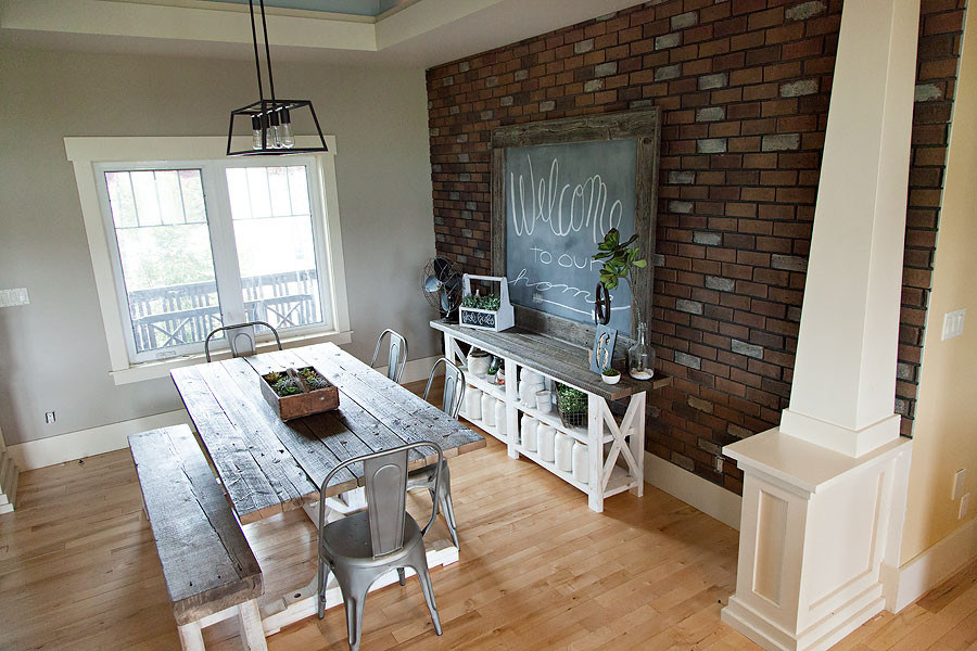Exemple d'une salle à manger montagne de taille moyenne avec un mur marron, parquet clair, un sol beige et un mur en parement de brique.