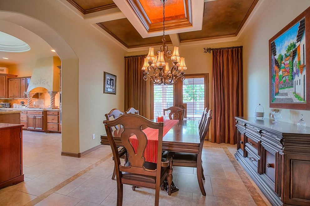 Photo of a traditional separate dining room in Albuquerque with beige walls, limestone floors and no fireplace.