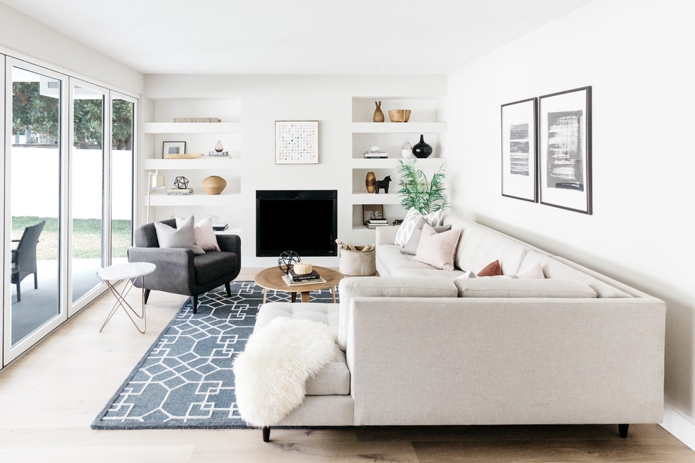 Inspiration for a transitional living room in Los Angeles with white walls, light hardwood floors, a standard fireplace, no tv and beige floor.