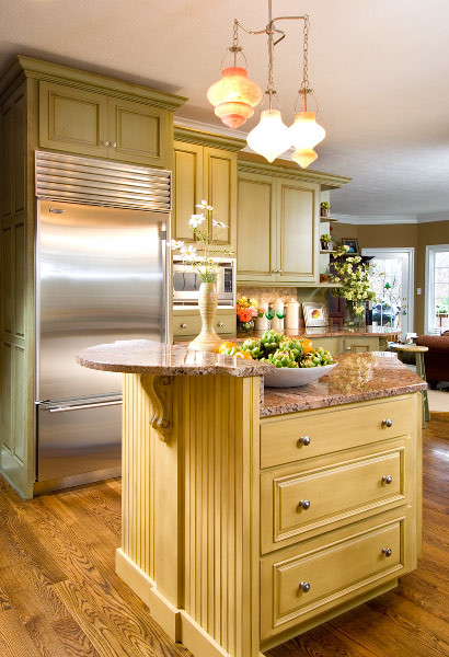Inspiration for a transitional medium tone wood floor eat-in kitchen remodel in Indianapolis with green cabinets, granite countertops, stainless steel appliances and an island