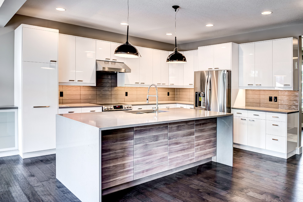 Mid-sized transitional l-shaped dark wood floor kitchen pantry photo in Edmonton with an undermount sink, flat-panel cabinets, white cabinets, quartz countertops, gray backsplash, subway tile backsplash, stainless steel appliances and an island