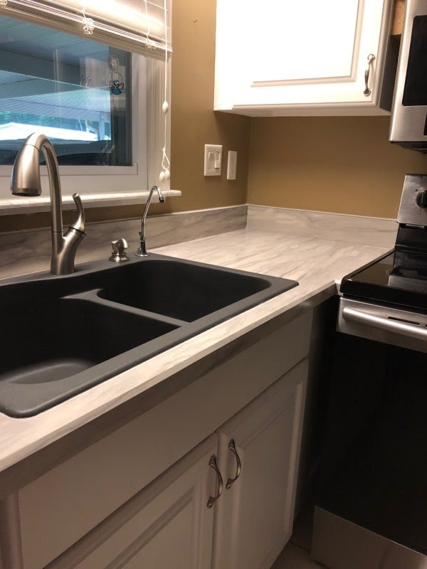 Eat-in kitchen - small galley eat-in kitchen idea with laminate countertops and no island