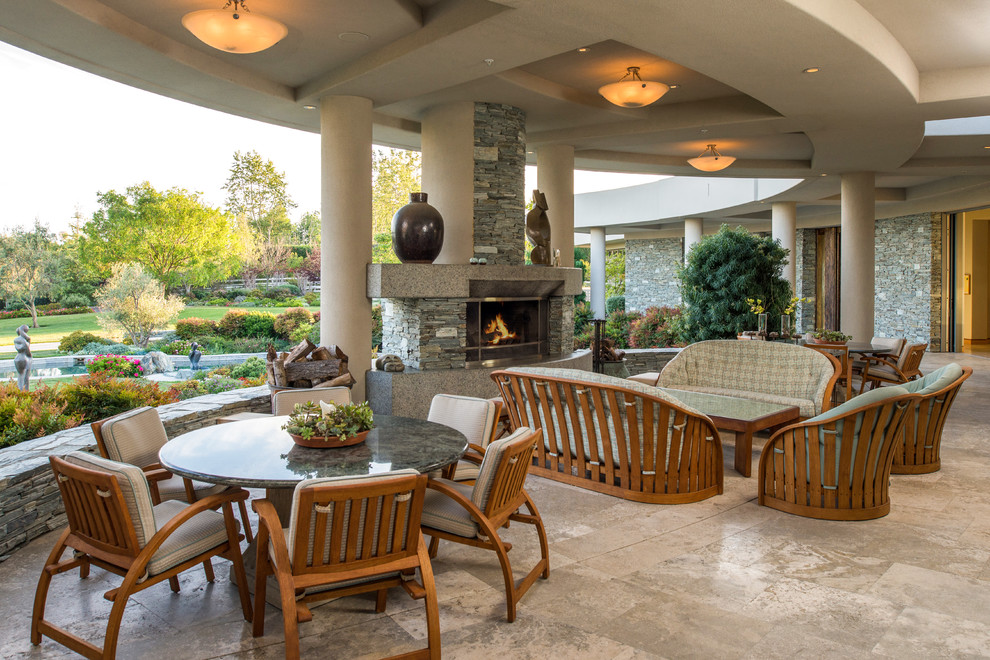 Inspiration for a transitional patio in San Diego with a roof extension and with fireplace.
