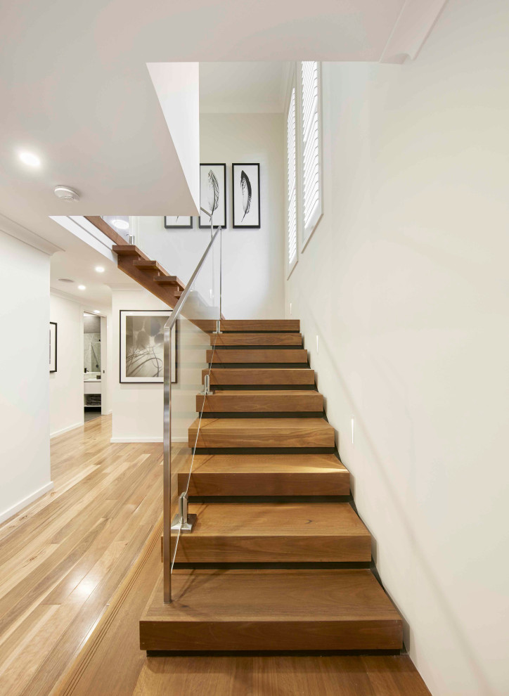 Photo of a contemporary staircase in Sydney with glass railing.