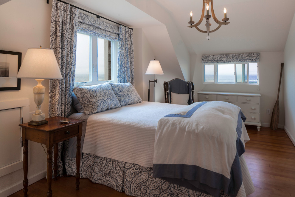 Inspiration for a coastal medium tone wood floor bedroom remodel in Seattle with white walls