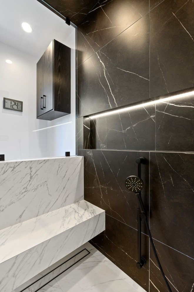 Photo of a bathroom in Los Angeles with black cabinets, black and white tile, porcelain tile, engineered quartz benchtops, white benchtops and a double vanity.