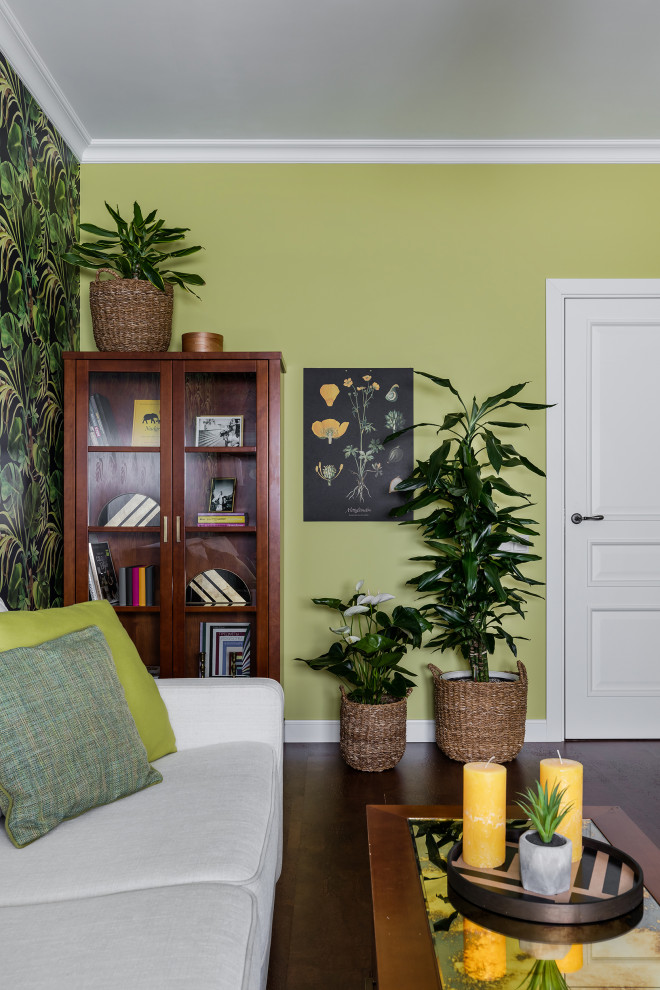 This is an example of a large classic study in Saint Petersburg with green walls, cork flooring, a freestanding desk, brown floors and wallpapered walls.