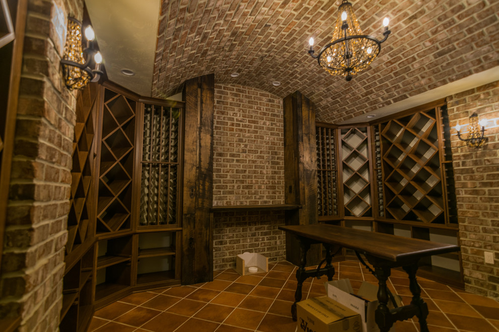 Inspiration for a large traditional wine cellar in Other with ceramic floors, storage racks and brown floor.
