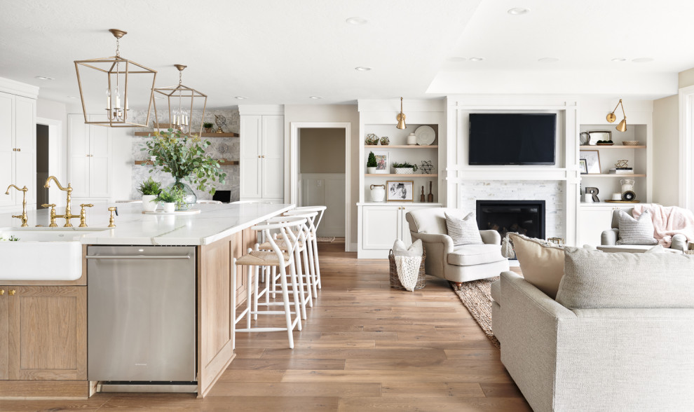 Inspiration for a large scandinavian u-shaped eat-in kitchen in San Francisco with a farmhouse sink, recessed-panel cabinets, white cabinets, quartzite benchtops, white splashback, marble splashback, stainless steel appliances, light hardwood floors, with island, beige floor and white benchtop.