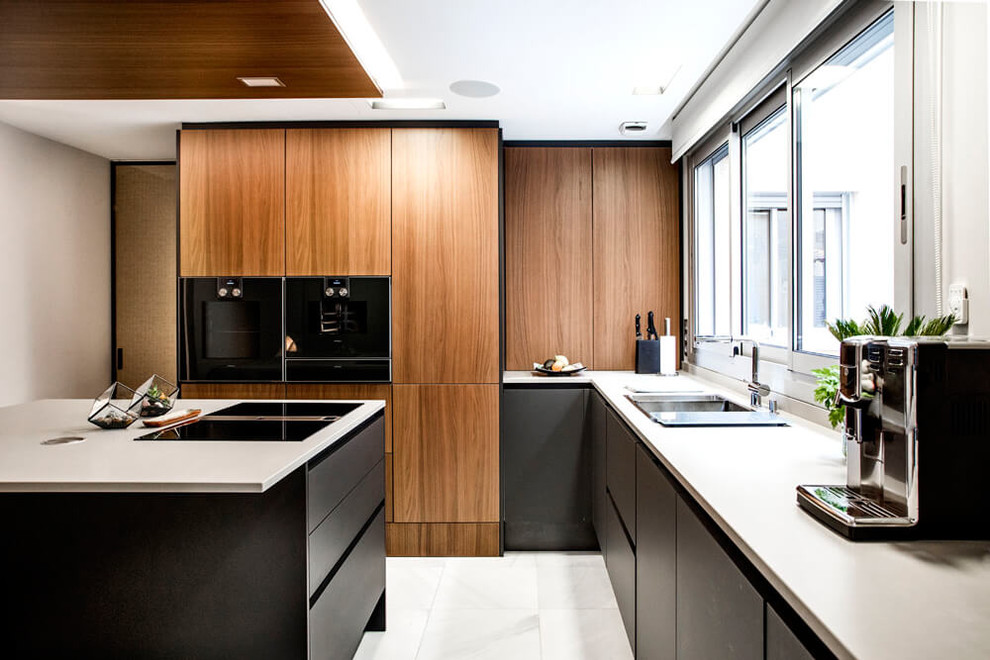 Design ideas for a small contemporary l-shaped kitchen in San Francisco with an undermount sink, flat-panel cabinets, medium wood cabinets, quartz benchtops, black appliances, marble floors, with island, white floor, white benchtop and window splashback.