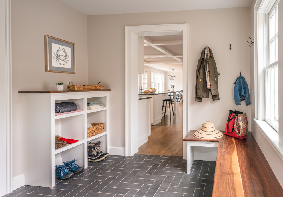 Mid-sized traditional mudroom in Boston with grey floor.