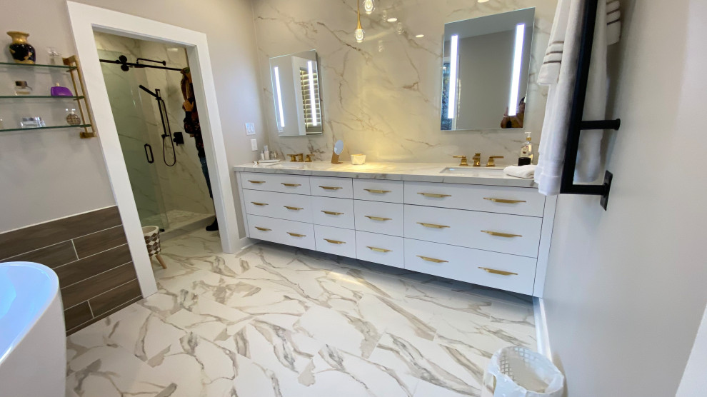 Photo of a large master bathroom in Other with flat-panel cabinets, a freestanding tub, an alcove shower, a two-piece toilet, beige walls, porcelain floors, an undermount sink, tile benchtops, a sliding shower screen, an enclosed toilet, a double vanity and a built-in vanity.