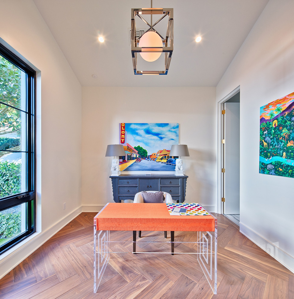 Photo of a mid-sized contemporary study room in Orlando with white walls, medium hardwood floors, a freestanding desk and brown floor.