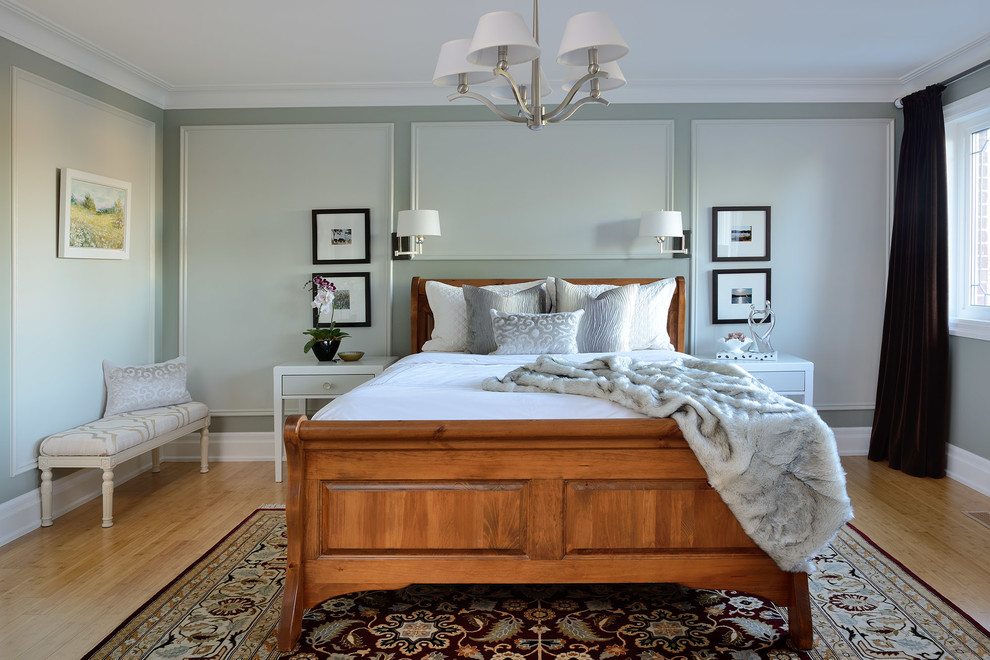 Inspiration for a large transitional master bedroom in Toronto with green walls, bamboo floors and brown floor.