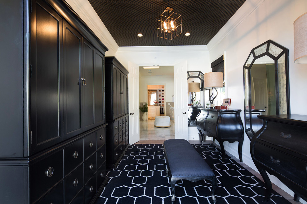Transitional dressing room in Los Angeles with black cabinets, recessed-panel cabinets and black floor.