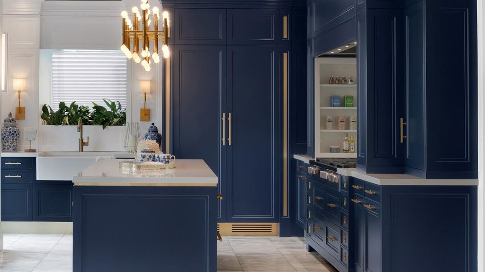 Inspiration for a large transitional porcelain tile and gray floor kitchen remodel in Miami with a farmhouse sink, recessed-panel cabinets, blue cabinets, solid surface countertops, paneled appliances and an island
