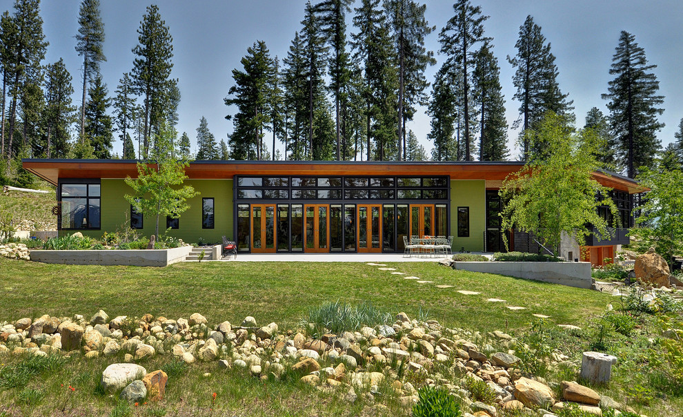 This is an example of a contemporary one-storey green exterior in Seattle.