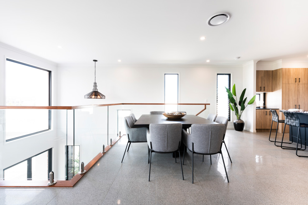 This is an example of a contemporary kitchen/dining room in Sunshine Coast with white walls and grey floors.