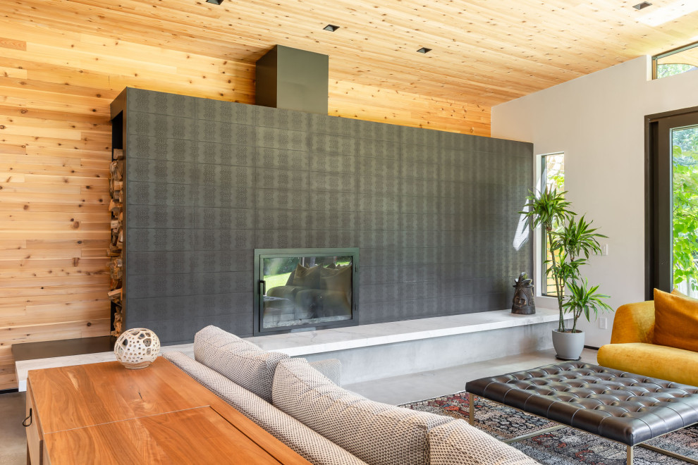 Inspiration for a mid-sized midcentury living room in Denver with a wood stove, a tile fireplace surround, grey floor, wood and wood walls.