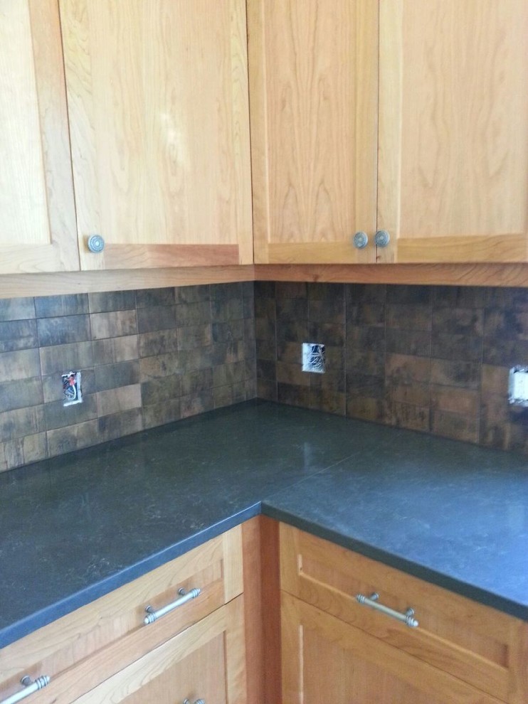 Inspiration for a mid-sized transitional kitchen remodel in Seattle with shaker cabinets, light wood cabinets, granite countertops, metallic backsplash, metal backsplash and stainless steel appliances