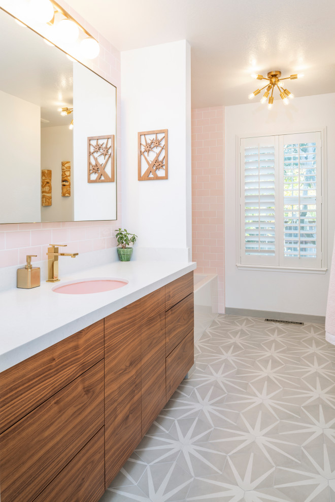 Traditional bathroom in Sacramento with medium wood cabinets, a corner tub, a corner shower, pink tile, ceramic tile, white walls, porcelain floors, an undermount sink, quartzite benchtops, multi-coloured floor and white benchtops.