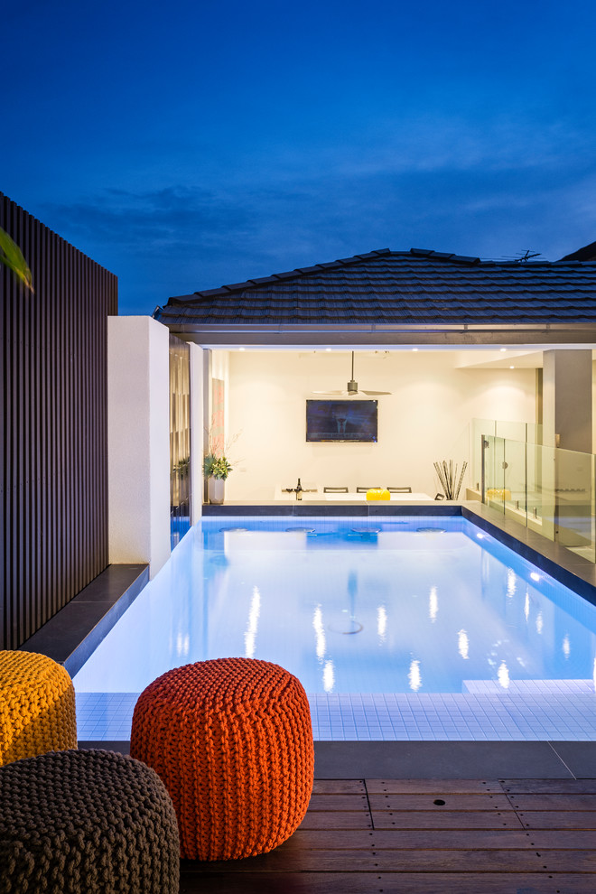Inspiration for a mid-sized contemporary backyard rectangular lap pool in Melbourne with decking.