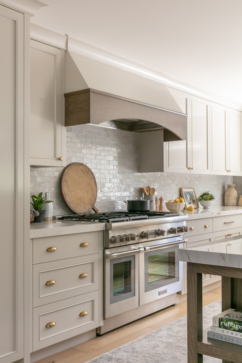 Classic Shaker-style RTA cabinets in a bright Canadian kitchen with elegant white finish and brass hardware for timeless appeal