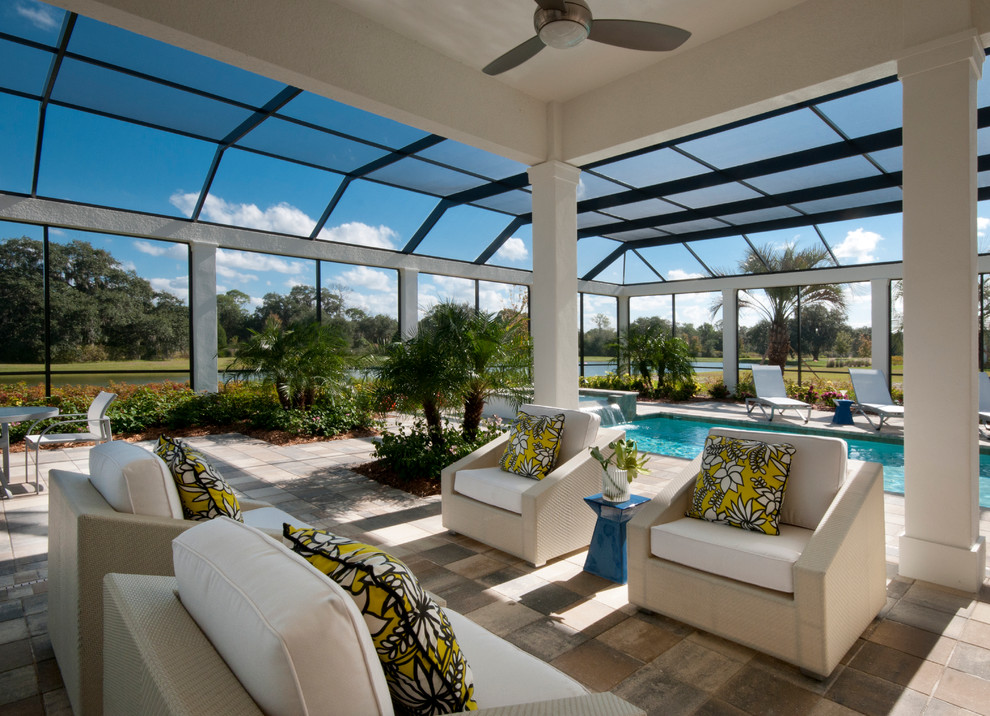 Photo of a contemporary patio in Tampa with a roof extension.