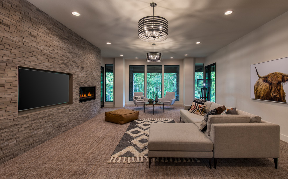Design ideas for a large modern enclosed home theatre in Portland with grey walls, carpet, a wall-mounted tv and grey floor.