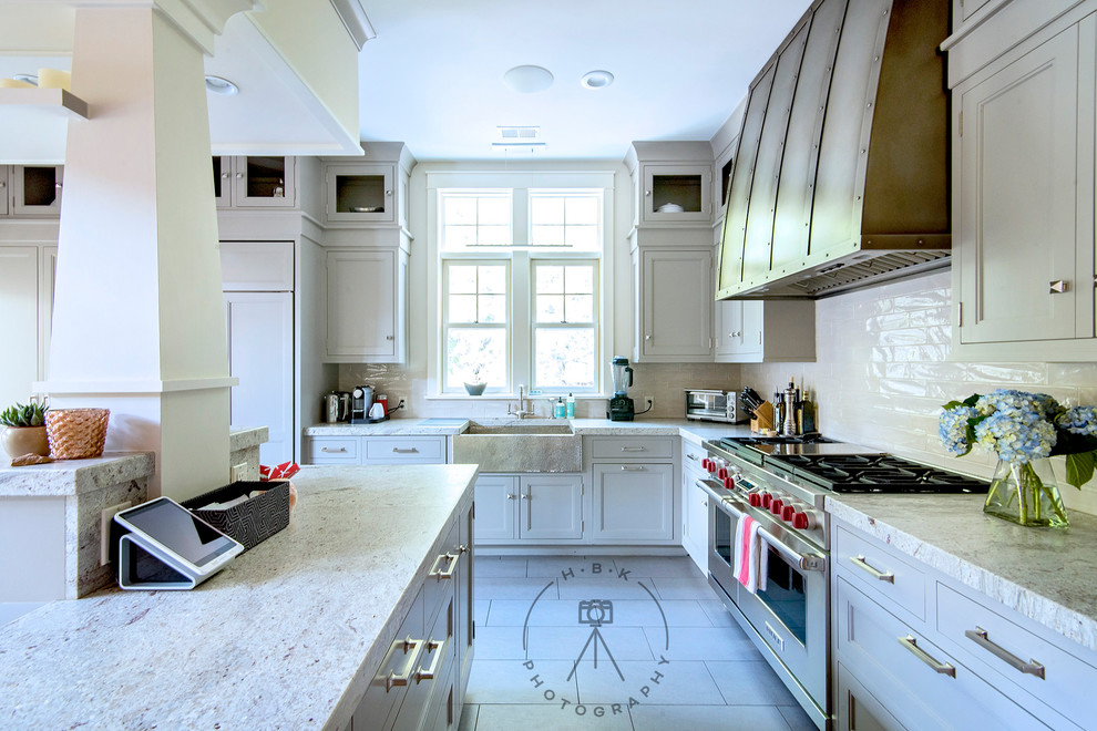 Inspiration for a large single-wall gray floor open concept kitchen remodel with a farmhouse sink, recessed-panel cabinets, gray cabinets, granite countertops, white backsplash, subway tile backsplash, stainless steel appliances, an island and multicolored countertops