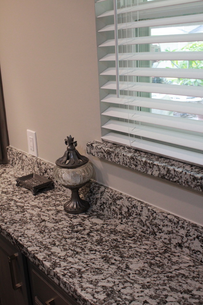 Example of a small transitional master white tile and porcelain tile porcelain tile and gray floor bathroom design in Houston with shaker cabinets, gray cabinets, gray walls, granite countertops and a hinged shower door